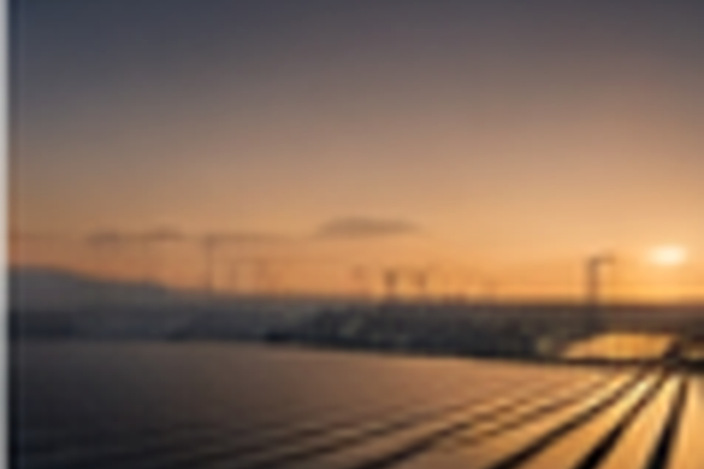 Large solar array at sunset with service access roads